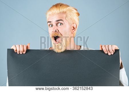 Man Holding Empty Sheet Of A Paper. Blank, Empty Paper, Billboard With Copy Space For Text