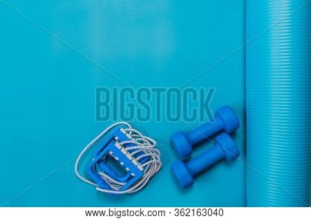 Two Dumbbells, Chesty Expander On Exercise Yoga Mat At Home Or In Fitness Studio. Blue Color Tools F