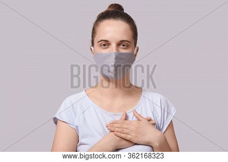 Horizontal Shot Of Good Looking Positive Female Standing Isolated Over Beige Background In Studio, L
