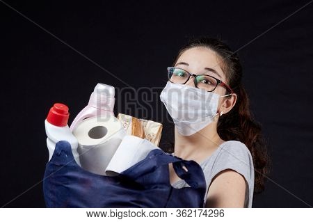 Young Woman In Protective Mask With A Bag Full Of Groceries From The Supermarket