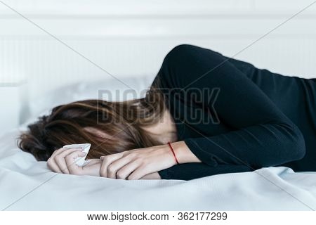 Young Woman Holding A Handkerchief Used To Dry Her Tears In Her Bed. Concept Of Violence And Mistrea