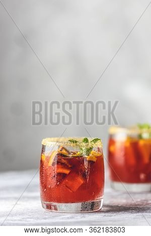 Glass Of Campari Gin Spritz Close Up. Cocktail Of Sweet, A Touch Of Bitter From The Campari And Gorg