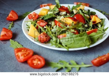 Fresh And Delicious Vegetarian Salad Mde Of Ruccola, Nectarine, Cherry Tomatoes, Spinach, Chia Seeds