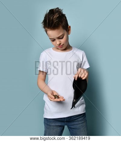 Small Cute Boy With Modern Hairstyle In Stylish Casual Clothing Standing And Showing Few Coins From 