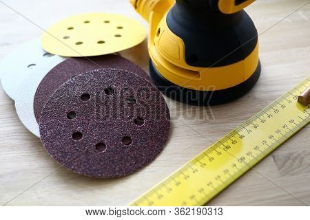 Close-up Of Sander Machine With Replacement Discs On Table. Grinding Equipment For Renovation And Co