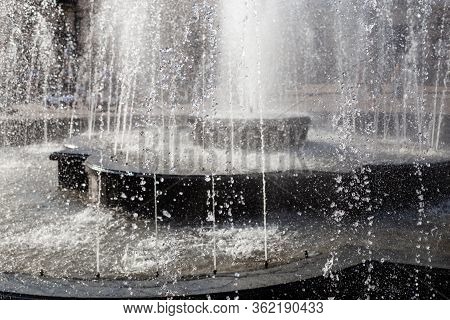 Splash And Drops In A Spring Fontain. Water Falling, Close Up Shot. Fontain Water Details.