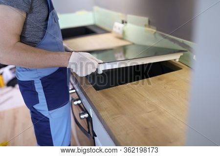Close-up Of Professional Handyman Setting Cookstove. Male In Protective White Gloves On Kitchen. Mov
