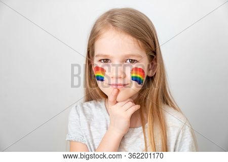 Child Girl With Blond Hair And Painted Cheeks A Rainbow. Stay Home. Flashmob Chasetherainbow.