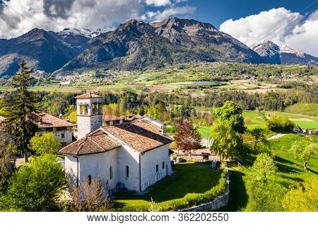Aerial View Of Valley With Church In Cares, Trentino, Green Slopes Of The Mountains Of Italy, Huge C