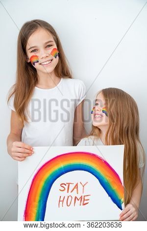 Happy Two Kid Girls With Blond Hair Drew A Rainbow And A Poster Stay Home. Flashmob Chasetherainbow.