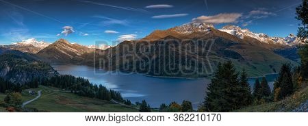 Lake In The French Alps. Reflection Of The Snowy Mountains In Autumn