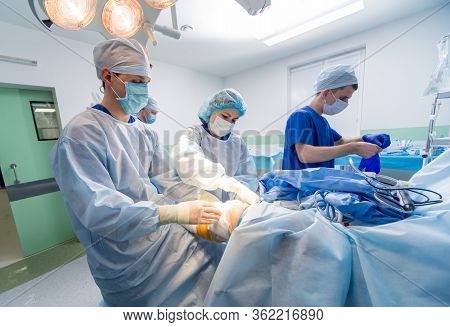 Arthroscope Surgery. Orthopedic Surgeons In Teamwork In The Operating Room