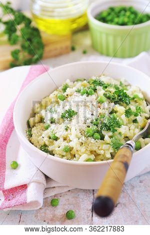 Italian Cuisine. Risi E Bisi, Venetian Cuisine.  Plate Of Green Pea Risotto With Green Pea, Grated P