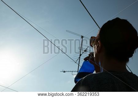 Woman Drinking Water On A Rooftop In The Morning