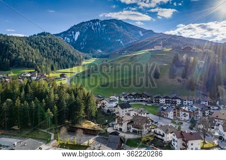 Aerial View Of Valley And Small City With Church, Green Slopes Of The Mountains Of Italy, Trentino, 