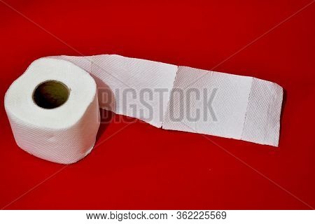 Roll Of Toilet Paper On Red Background