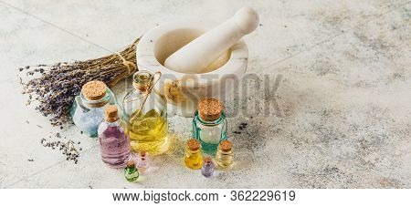 Aromatic Oils In Glass Bottles, Aromatic Salts, Marble Mortar And Dry Lavender. Concept Natural Ogra