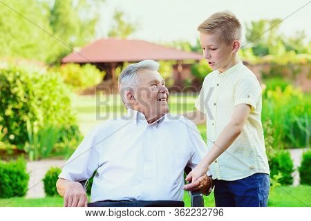 Teen Grandson Visiting His Old Grandfather At Nurising Home