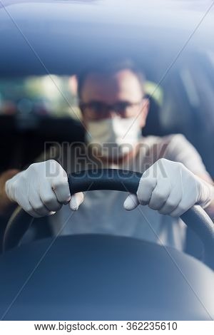 Close Up Of Driver In Protective Mask With Hands In Rubber Gloves On Steering Wheel, Covid-19 Protec
