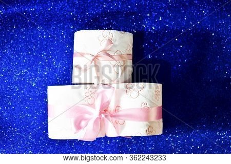 Rolls Of Toilet Paper On Glitter Blue Background