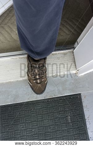 Toronto, Canada, April 2020 - Male Foot In Sport Shoe Resisting The Urge To Step Out During The Cove