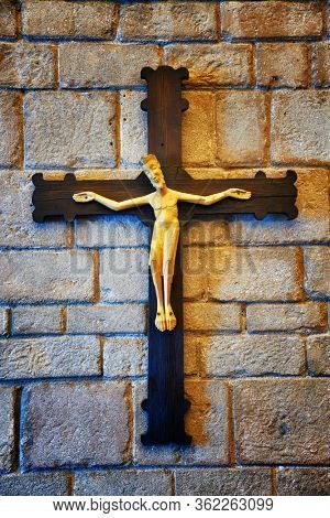 Jesus statue on wall. Romanesque monastery in village in Pueblo Espanol Barcelona, Spain