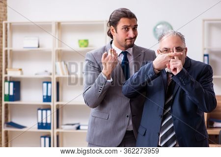 Two employees in pandemic concept at workplace