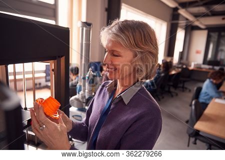 Mature Female College Student Studying Engineering Using 3D Printing Machine