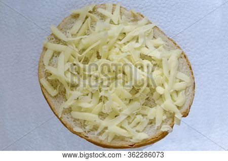 Sliced ​​bread With Grated Yellow Cheese Or  Kashkaval And Butter For Breakfast, Sofia, Bulgaria