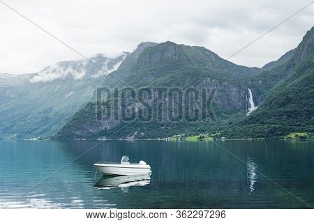 Norwegian landscape with a boat in the Lusterfjord fjord. Commune Luster, Norway. Mountain and waterfall view