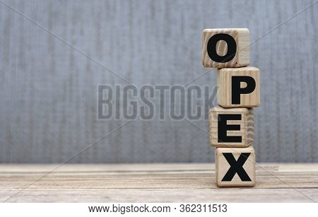 Concept Of The Word Opex On Cubes On A Gray Background. Business Concept.