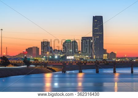 Oklahoma City, Oklahoma, USA downtown skyline on the Oklahoma River at dusk.