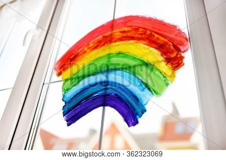 Drawing Of Rainbow On Home Window While Coronavirus Quarantine. Sign Rainbow Is Symbol Of Hope, Mean