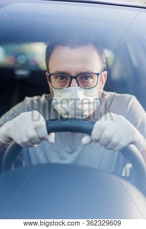 Close Up Of Driver In Protective Mask With Hands In Rubber Gloves On Steering Wheel, Covid-19 Protec