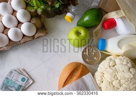 Flat Lay From A Set Of Different Products And A Few Russian Banknotes On A Light Surface. Delivery O