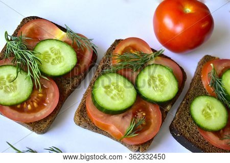 Several Diet Sandwiches With Cucumber And Tomato From Black Bread