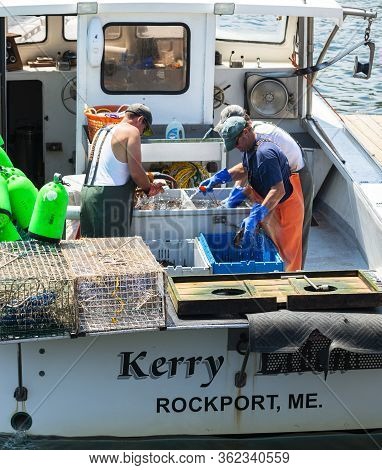 Rockport, Maine, Usa - 4 August 2017: Three Fishermen On Their Fishing Boat Sorting The Days Catch O