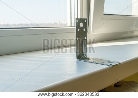 Metal Corner For Fixing Wooden Boards Close Up On The Windowsill