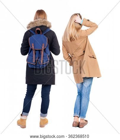 Back view of two young woman in winter jackets. Rear view people collection. backside view of person. Rear view. Isolated over white background. She clung to his girlfriend