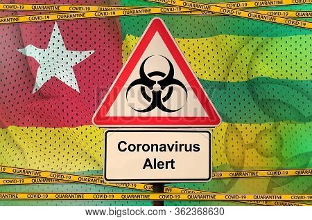 Togo Flag And Covid-19 Biohazard Symbol With Quarantine Orange Tape. Coronavirus Or 2019-ncov Virus 