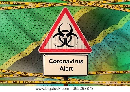 Tanzania Flag And Covid-19 Biohazard Symbol With Quarantine Orange Tape. Coronavirus Or 2019-ncov Vi
