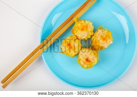 Siu Mai - Chinese Steamed Pork Dumplings On Blue Plate Isolated On White Background.