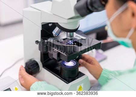 Doctor And Microbiologist With Vacuum Tubes For Samples With Covid 19 Infection Atypical Pneumonia V