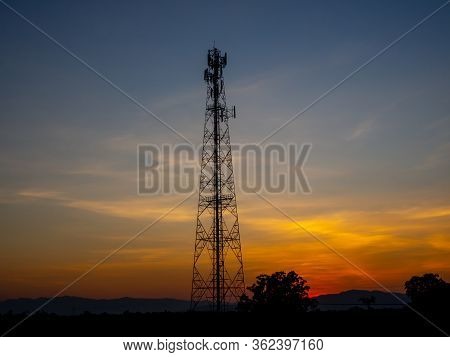 Electric Pylon At Sunset. Silhouette High Voltage Electric Tower On Sunset Time And Sky On Sunset Ti