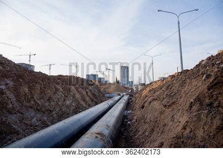 Laying Of Underground Storm Sewer Pipes At The Construction Site. Installation Of Water Main And San