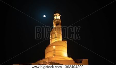 Doha,qatar- 3 March 2020: Background Image Of Fanar Minaret With The Full Moon Background.