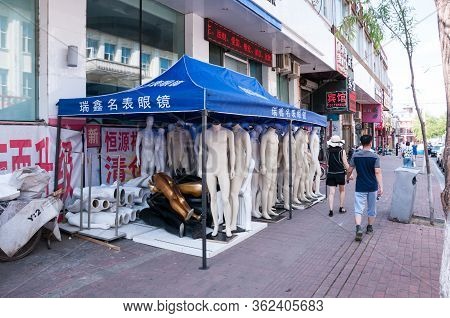 China, Heihe, July 2019: Tent With Mannequins. Street Of The Chinese City Of Heihe In Summer