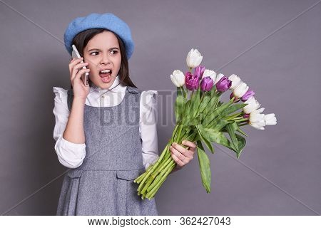 Portrait Of A Beautiful Schoolgirl Lady French Brunette, In A Stylish Blue Beret Hat, In Her Hands W