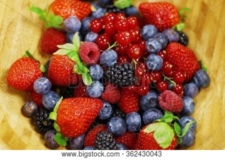 Assorted Fresh Berries With Wooden Background, Healthy Food Concept