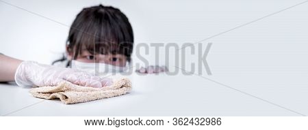 Young Woman Housewife Is Cleaning, Wiping Down Home Table Surface To Stop The Spread Of Infection Wi